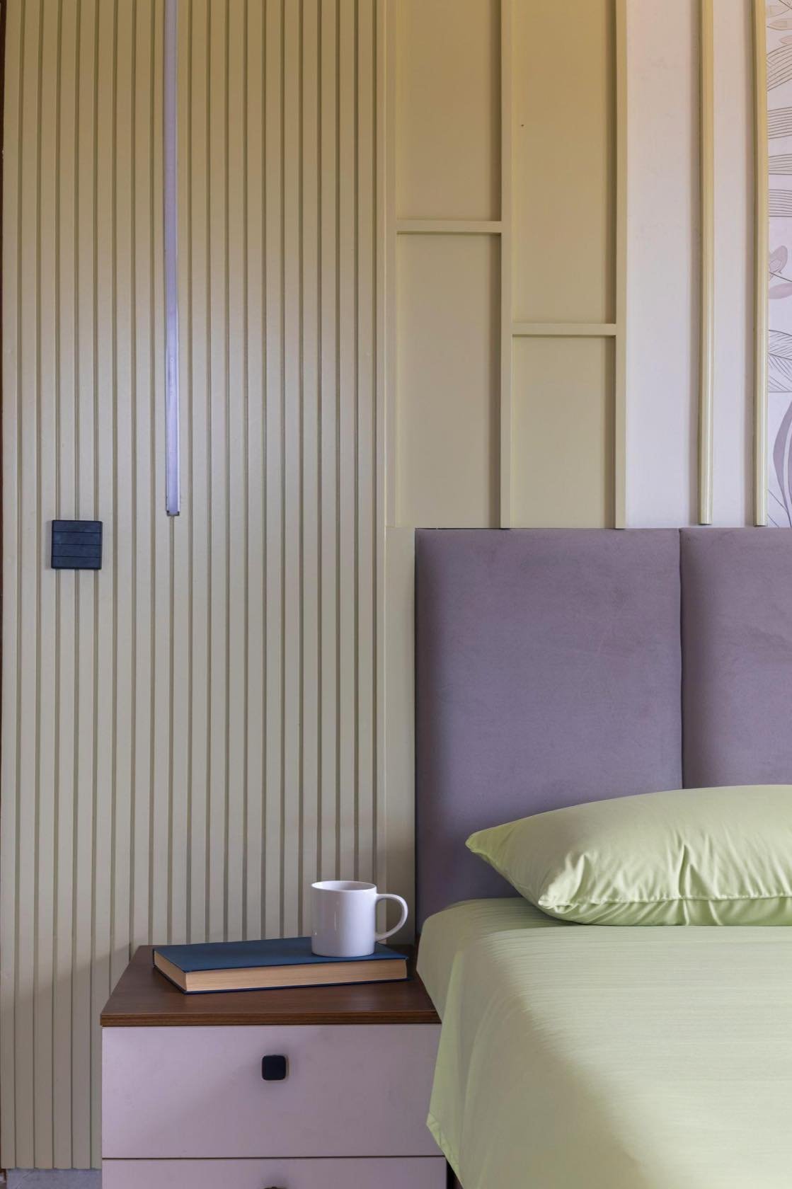 Bedroom with a soft lilac upholstered headboard