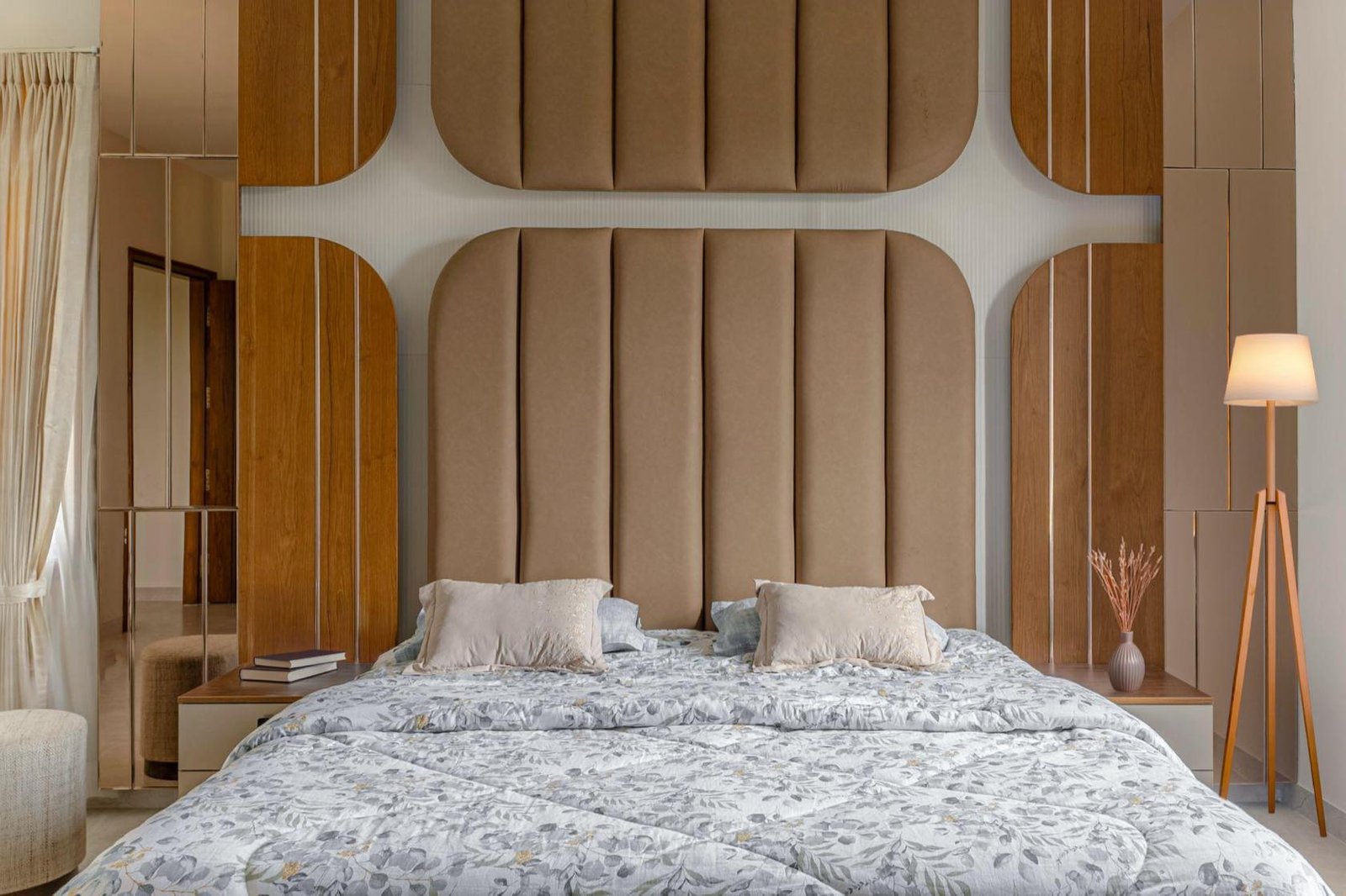 Master bedroom with a fluted upholstered headboard wall