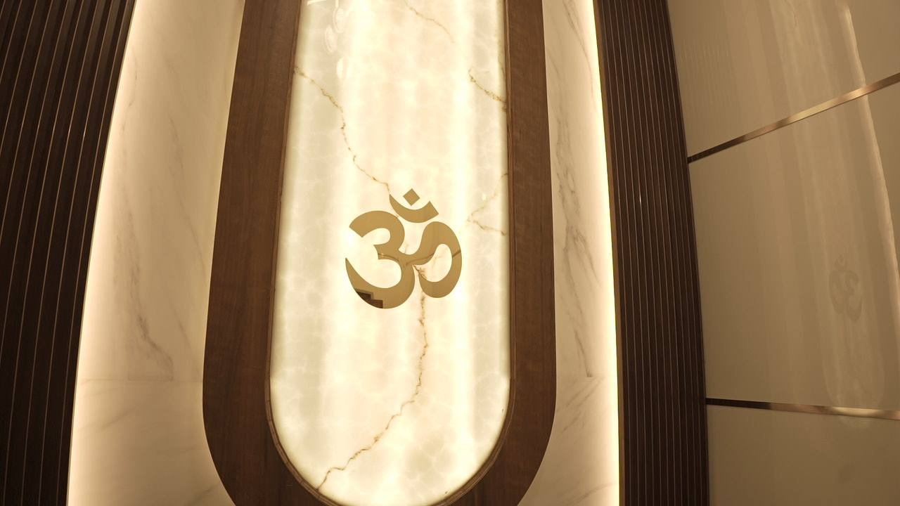 Backlit alabaster arch with a brass Om
