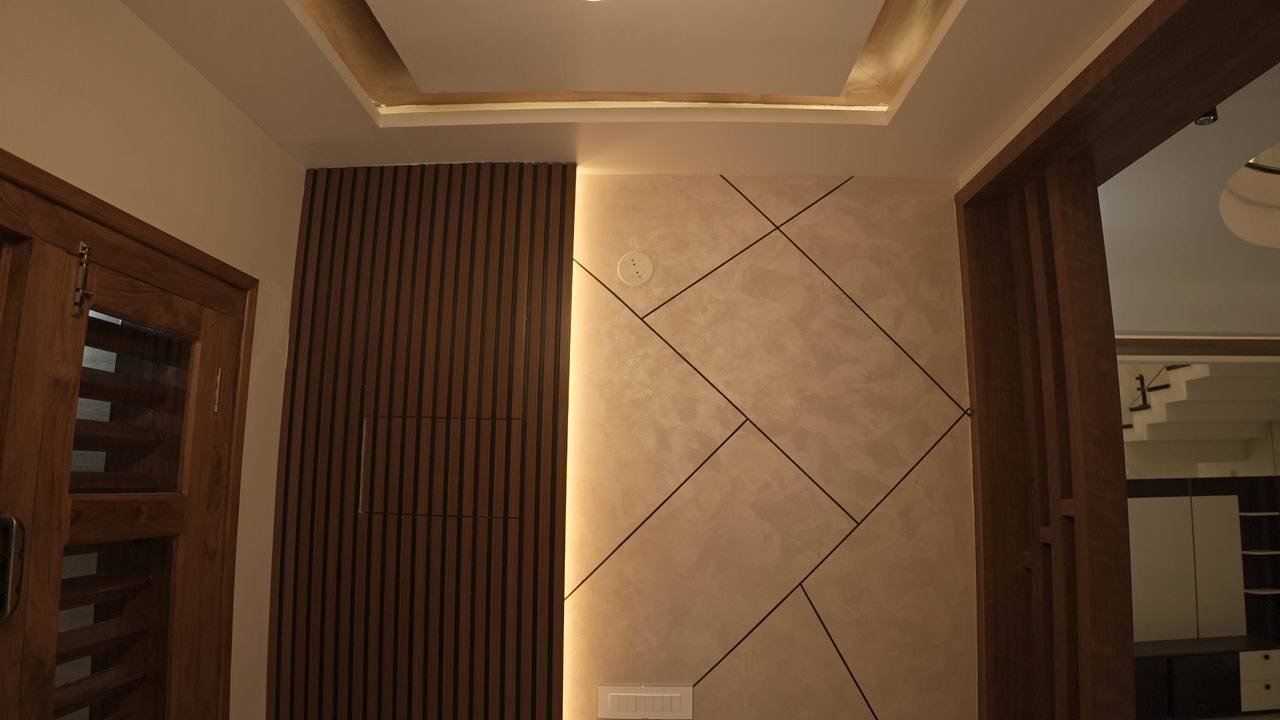 Wall with diagonal inlay lines beside a fluted timber panel