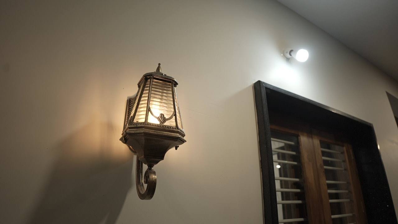 Lantern wall light beside a timber window outside