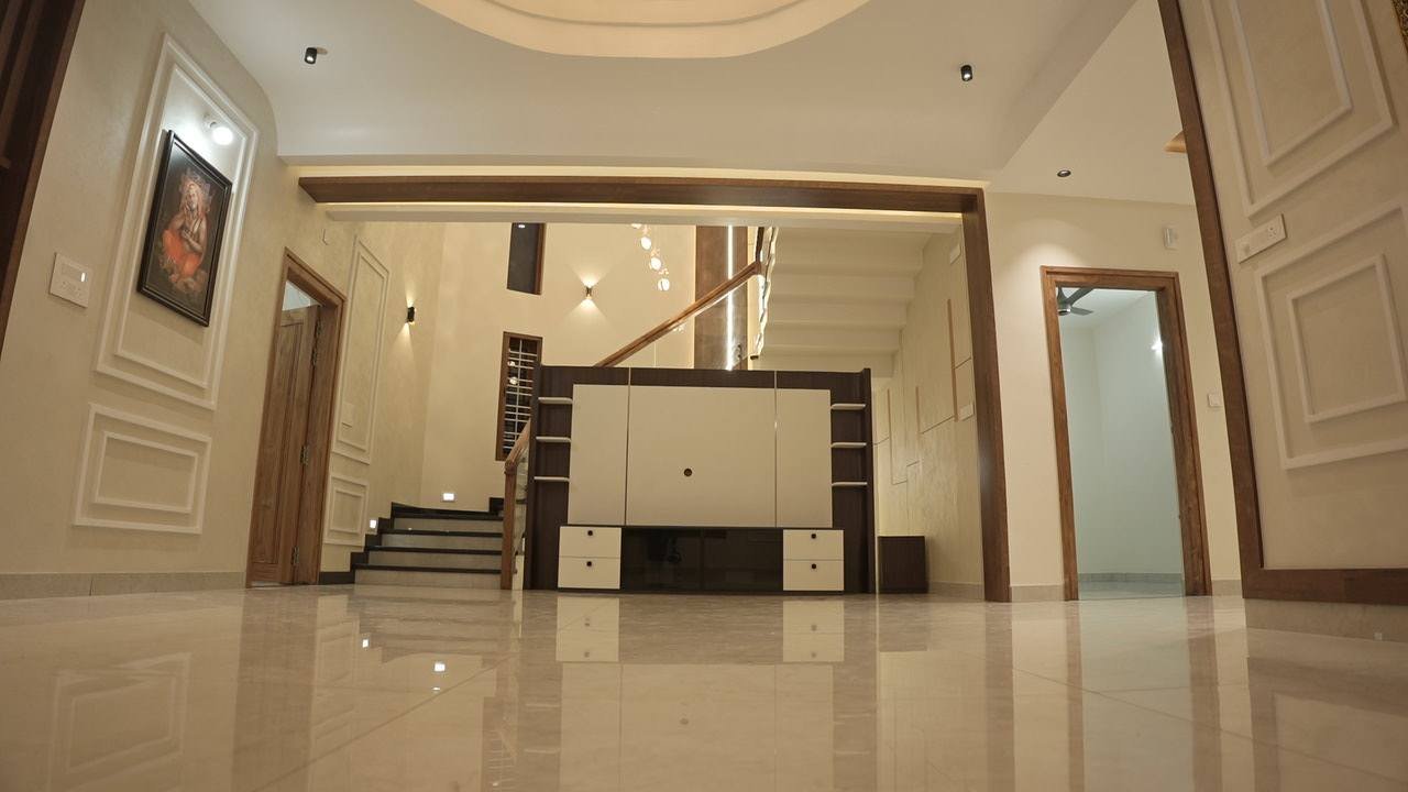 Living room opening toward the staircase and media wall